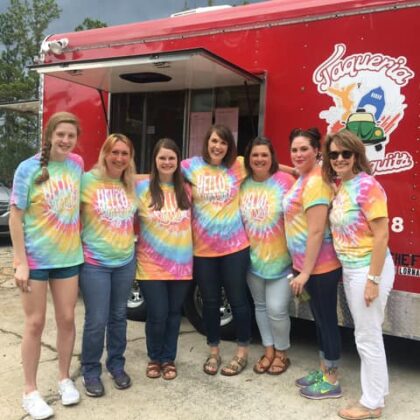employees in front of food truck