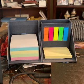 desk organizational cube with sticky notes, pen holder, and multi-colored markers 